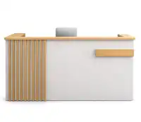 White reception counter with vertical wooden paneling.